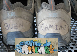 The backs of sneakers with the words Buen Camino written across them