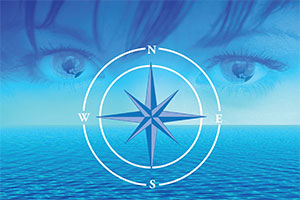 Image of Compass over sky and water