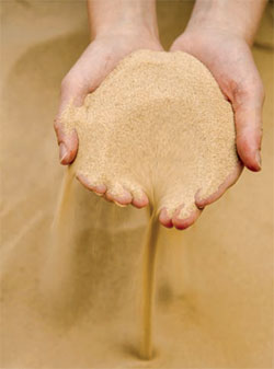 hands holding sand