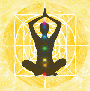 individual sitting in lotus position with chakras