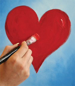 someone painting heart on a blue canvas