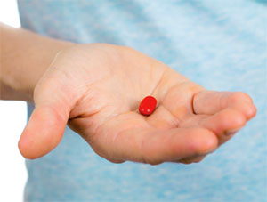 Hand holding a pill