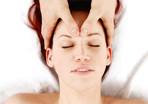 Woman getting her head massaged