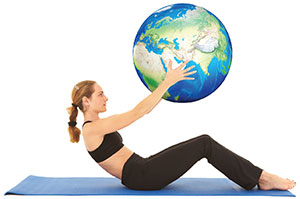 Woman on yoga mat holding the globe