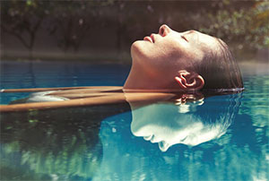 Woman floating in pool of water