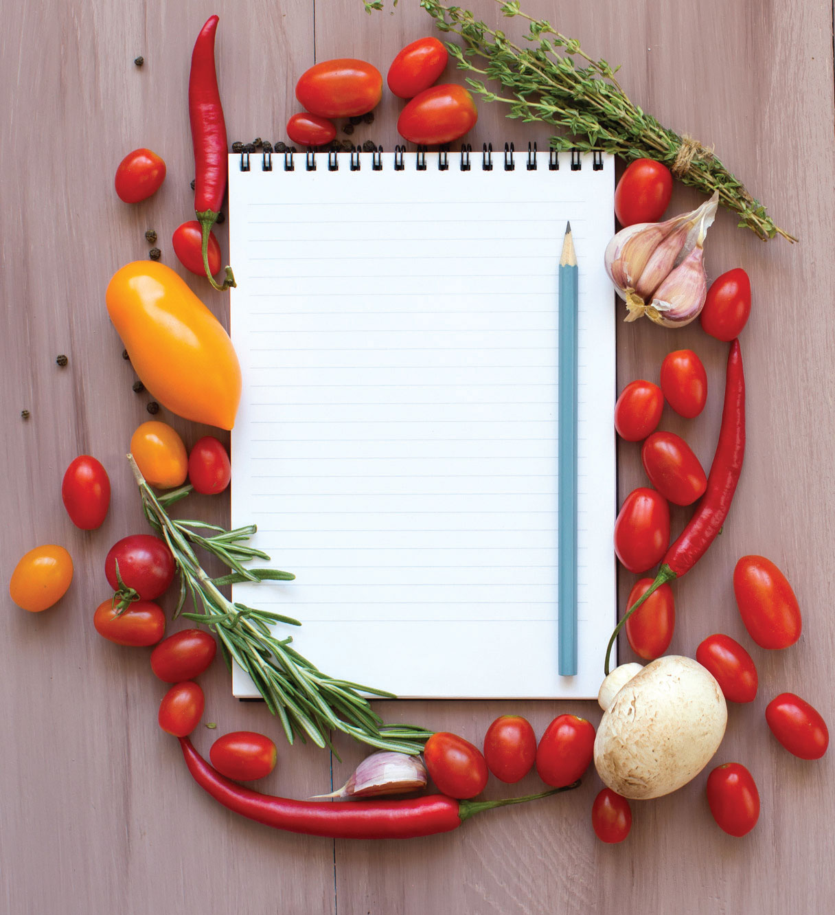 A notepad surrounded by vegetables