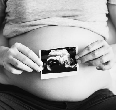 future mom holding ultrasound photo