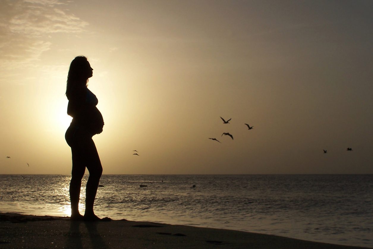 image of pregnant women at sunset