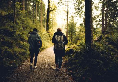 two friends walking in woods