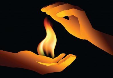 two hands holding a flame