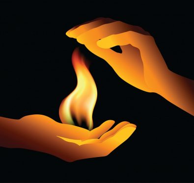two hands holding a flame