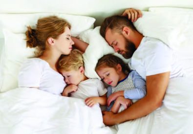 Sleeping family in bed